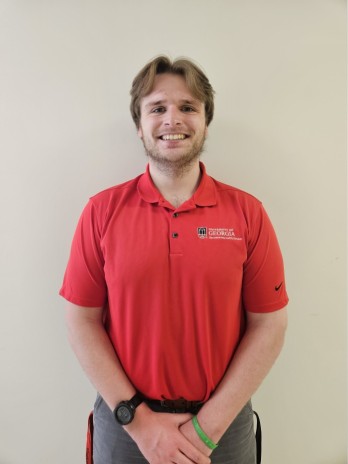 Photo of Charles Gochenour wearing a red shirt on a white background